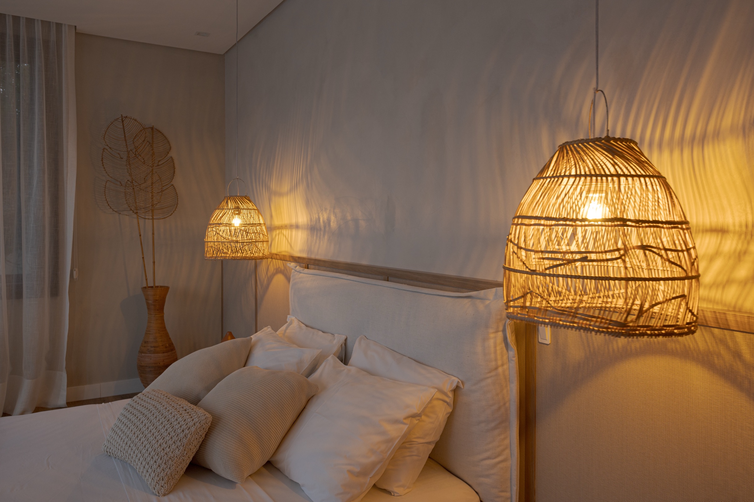 Quarto com almofadas e luminárias de fibra acesas